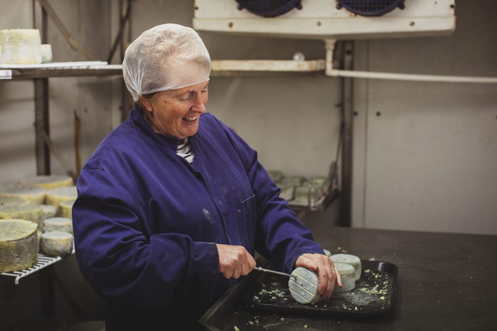 Cheesemaker Menai Jones uses a metal spike to pierce small blue cheeses